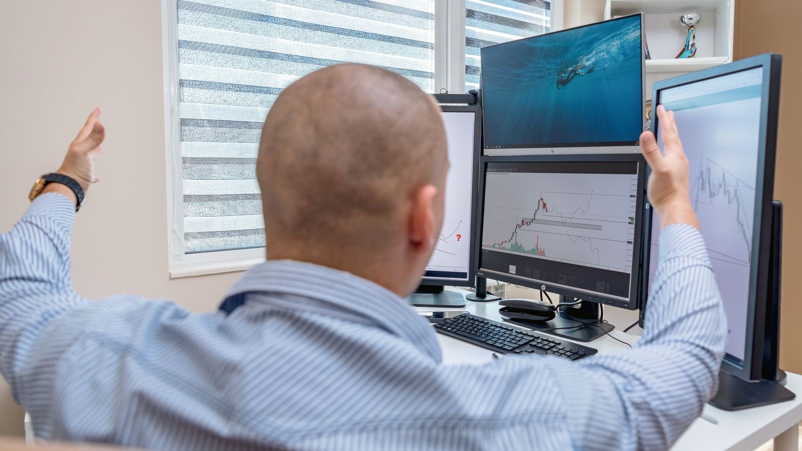 A stock trader celebrating while monitoring multiple screens with financial charts, representing the value stock rotation of 2026